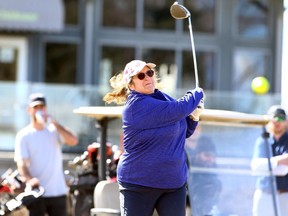 Sharon Dyler tees off on a warm first day of spring as HeatherGlen Golf Course opened for the season on Saturday, March 20, 2021.