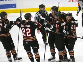 The Calgary Hitmen celebrate after Jackson van de Leest scored a goal against the Medicine Hat Tigers at the Seven Chiefs Sportsplex on on Tsuut’ina Nation on Sunday, March 14, 2021.