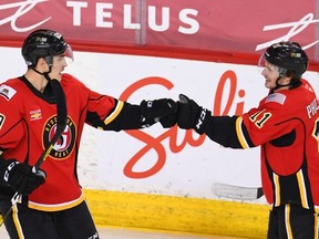 Stockton Heat centre Adam Ruzicka, left, celebrates with linemate Matthew Phillips. They have combined for 15 points in the first five games of 2021. (Courtesy of Stockton Heat)