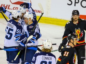 Calgary Flames Chris Tanev reacts after a goal by the Winnipeg Jets during NHL hockey in Calgary on Friday March 26, 2021. Al Charest / Postmedia