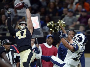 In this Aug. 30, 2018, file photo, New Orleans Saints linebacker Alex Anzalone intercepts a pass intended for Los Angeles Rams running back Nick Holley during an NFL preseason football game in New Orleans. Holley signed with the CFL's Calgary Stampeders earlier this week.