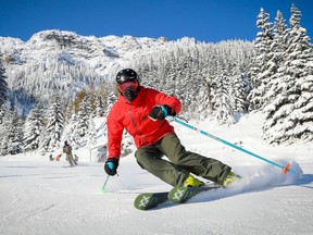 A skier makes turns down the slopes of Mount Norquay.