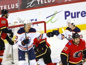 Edmonton Oilers Jesse Puljujarvi and Ryan Nugent-Hopkins celebrate their first goal on Calgary Flames goalie Jacob Markstrom in first period action at the Scotiabank Saddledome in Calgary on Wednesday night.