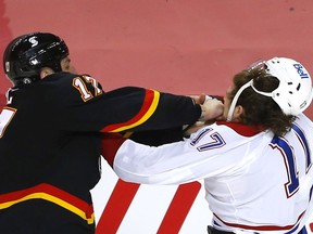 Calgary Flames forward  Milan Lucic battles the Montreal Canadiens' Josh Anderson in second-period action at the Scotiabank Saddledome on Thursday night.
