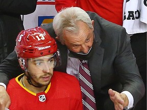 Calgary Flames head coach Daryl Sutter talks with forward Johnny Gaudreau during NHL action against the Montreal Canadiens at the Scotiabank Saddledome in Calgary on Saturday, March 13, 2021. Calgary won the game 3-1.
