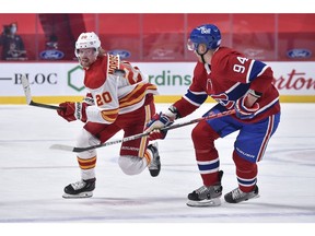 Joakim Nordstrom of the Calgary Flames and Corey Perry of the Montreal Canadiens chase the puck during the first period at the Bell Centre on April 14, 2021 in Montreal, Canada.