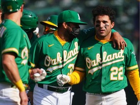 OAKLAND, CALIFORNIA - APRIL 21: Ramon Laureano #22 of the Oakland Athletics celebrates with his teammates after reaching first on an error to walk off in the tenth inning against the Minnesota Twins at RingCentral Coliseum on April 21, 2021 in Oakland, California.