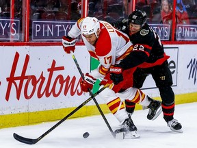 The Calgary Flames’ Milan Lucic battles the Ottawa Senators’ Nikita Zaitsev at the Canadian Tire Centre in Ottawa on March 24, 2021.