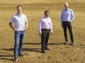 From left to right. Brent Piercy, one of the board of directors of the Elbow Valley Community Association, Anil Tahiliani, president of the Discovery Ridge Community Association, and Doug Leighton, director of the Discovery Ridge Community Association, stand in the land that has become a storm water pond instead of a park in Calgary's southwest on Tuesday, April 6, 2021.