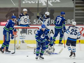 A despondent trio of Vancouver Canucks reacts after the Jets scored a goal against them on March 24. The Canucks haven't played since. Will that be their final game of the season?