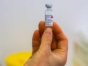 A vial of the AstraZeneca COVID-19 vaccine is prepared in a vaccination centre at Newmarket Racecourse, amid the coronavirus disease outbreak in Newmarket, Britain March 26, 2021.