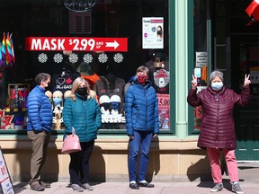 Some Calgarians were pretty excited to get immunized as they waited outside the large COVID-19 vaccination site at the Telus Convention Centre on Monday, April 12, 2021.