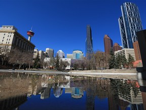 The downtown Calgary skyline is reflected in a pool of water at Olympic Plaza on Monday, April 26, 2021. Calgary city council is considering a 10-year plan to revitalize the downtown core.