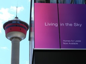 The Calgary Tower is framed with the signage on the Telus Sky building advertising residential units on Monday, April 26, 2021. Calgary city council is considering a 10-year plan to revitalize the downtown core which includes having more people living downtown.