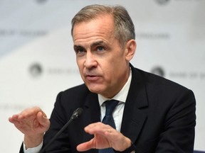 Mark Carney, seen here during his tenure as Governor of the Bank of England, attends a news conference at Bank Of England in London, March 11, 2020.