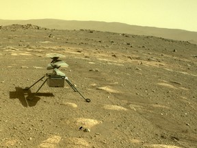 This NASA photo obtained on April 6, 2021, shows Ingenuity helicopter seen on Mars as viewed by the Perseverance rovers rear Hazard Camera on April 4, 2021.