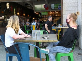 Patrons enjoy the sun on the outdoor patio at Blanco Cantina on 17 Ave. as Premier Jason Kenney announced new measures for Alberta to fight the current surge in COVID cases in Calgary on Tuesday, April 6, 2021.