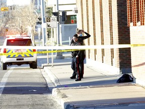 Calgary police investigate a serious stabbing in a back alley on 11 St. and 7 Ave. S.W. in Calgary on Thursday, April 15, 2021.