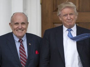 In this file photo taken on Nov. 20, 2016, President-elect Donald Trump meets with former New York City Mayor Rudy Giuliani at the clubhouse of the Trump National Golf Club in Bedminster, N.J.