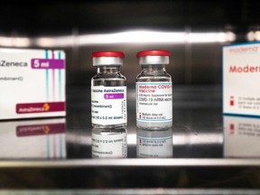 Vials of the AstraZeneca, left, and Moderna COVID-19 vaccines are pictured at the pharmacy of the Sant'Andrea hospital in Vercelli, Piedmont, on April 15, 2021.
