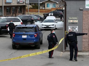 Police investigate a scene where gunshots were fired outside the Money Back Bottle Depot on 37th Street S.W. on Thursday, April 8, 2021. There were no injuries in the incident.