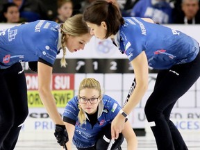 Fourth Alina Paetz, centre, delivers a rock for Silvana Tirinzoni's Switzerland team as lead Melanie Barbezat, left, and second Esther Neuenschwander sweep during the women's final at the Grand Slam of Curling's Princess Auto Elite 10 tournament at Thames Campus Arena in Chatham, Ont., on Sunday, Sept. 30, 2018. Mark Malone/Chatham Daily News/Postmedia Network