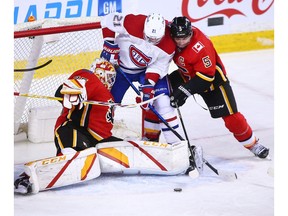 Calgary Flames goaltender Jacob Markstrom and Flames captain Mark Giordano struggle with the Montreal Canadiens' Eric Staal and a loose puck during NHL action at the Scotiabank Saddledome in Calgary on Saturday, April 24, 2021. 

Gavin Young/Postmedia