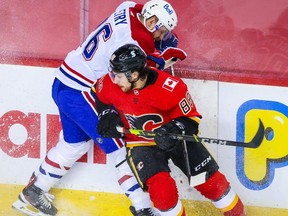 Apr 24, 2021; Calgary, Alberta, CAN; Calgary Flames left wing Andrew Mangiapane (88) and Montreal Canadiens defenseman Jeff Petry (26) battle for the puck during the second period at Scotiabank Saddledome. Mandatory Credit: Sergei Belski-USA TODAY Sports ORG XMIT: IMAGN-445653
