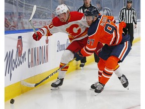 Calgary Flames forward Joakim Nordstrom (20) and Edmonton Oilers forward Connor McDavid (97) chase a loose puck during the first period  at Rogers Place. Perry Nelson-USA TODAY Sports