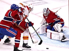 Apr 16, 2021; Montreal, Quebec, CAN; Montreal Canadiens goaltender Jake Allen (34) makes a save against Calgary Flames left wing Matthew Tkachuk (19) as defenseman Ben Chiarot (8) defends during the first period at Bell Centre. Mandatory Credit: Jean-Yves Ahern-USA TODAY Sports ORG XMIT: IMAGN-445595