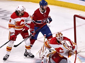 Apr 16, 2021; Montreal, Quebec, CAN; Montreal Canadiens right wing Tyler Toffoli (not pictured) scores a goal against Calgary Flames goaltender Jacob Markstrom (25) and right wing Joel Armia (40) in front of defenseman Christopher Tanev (8) during the second period at Bell Centre. Mandatory Credit: Jean-Yves Ahern-USA TODAY Sports ORG XMIT: IMAGN-445595