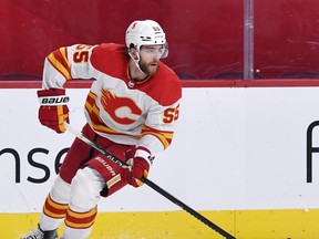 Apr 14, 2021; Montreal, Quebec, CAN; Calgary Flames defenseman Noah Hanifin (55) plays the puck during the second period of the game against the Montreal Canadiens at the Bell Centre. Mandatory Credit: Eric Bolte-USA TODAY Sports ORG XMIT: IMAGN-445579