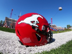 A Calgary Stampeders helmet and football rest on the sidelines during practise at McMahon Stadium in Calgary, Thursday August 15, 2019. Gavin Young/Postmedia