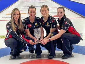 Skip Rachel Homan, third Emma Miskew, second Sarah Wilkes and lead Joanne Courtney hold the trophy after capturing the Pinty's Grand Slam of Curling Humpty's Champions Cup women's title at WinSport's Markin MacPhail Centre in Calgary on Monday, April 19, 2021.