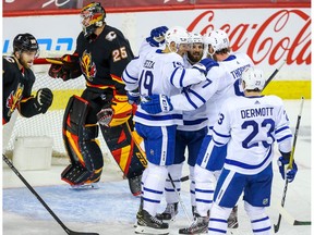 The Toronto Maple Leafs’ Jason Spezza celebrates with teammates after scoring a goal on goalie Jacob Markstrom of the Calgary Flames at the Saddledome in Calgary on Monday, April 5, 2021.