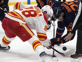 The Edmonton Oilers' Leon Draisaitl (29) takes a face-off against the Calgary Flames' Elias Lindholm (28) during third period NHL action at Rogers Place, in Edmonton Thursday April 29, 2021. The Flames won 3-1. Photo by David Bloom