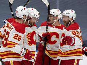 Calgary Flames celebrate their second goal against the Edmonton Oilers during second period NHL action at Rogers Place in Edmonton on Thursday, April 29, 2021.