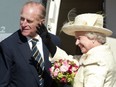 Prince Philip and Queen Elizabeth II prepare to board a jet for home at Calgary International Airport Wednesday.