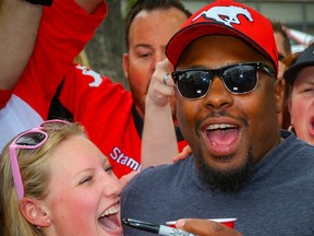 Nik Lewis poses for a photo with Nik Lewis Nation fans during a tailgate party before a game between the Calgary Stampeders and the Montreal Alouettes,the CFL receptions leader signed a one-day contract with Stampeders before announcing his retirement last Friday. Al Charest/Postmedia