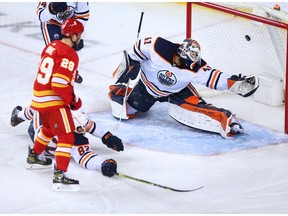 Calgary Flames forward Sean Monahan’s shot sails into the net past Edmonton Oilers goaltender Mike Smith at the Scotiabank Saddledome in Calgary on Saturday, April 10, 2021.