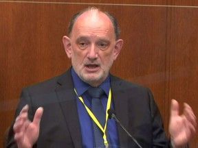 The former chief medical examiner of Maryland, Dr. David Fowler, answers questions during the thirteenth day of the trial of former Minneapolis police officer Derek Chauvin for second-degree murder, third-degree murder and second-degree manslaughter in the death of George Floyd in Minneapolis, Minnesota, U.S. April 14, 2021 in a still image from video.