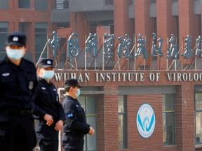 Security personnel keep watch outside the Wuhan Institute of Virology during the visit by the World Health Organization (WHO) team tasked with investigating the origins of the coronavirus disease (COVID-19), in Wuhan, Hubei province, China February 3, 2021.