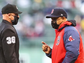 BOSTON, MA - MAY 11:  Head coach Alex Cora of the Boston Red Sox argues with the umpire in the first inning of a game against the Oakland Athletics at Fenway Park on May 11, 2021 in Boston, Massachusetts.
