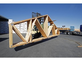 A worker loads finished trusses for homes onto a truck at Wasatch Truss in Utah. Lumber prices have sky rocketed along with supply shortages the last several months have plagued the construction industry.