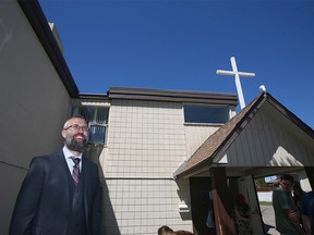 Pastor Tim Stephens waits outside Fairview Baptist Church after the Sunday service in Calgary on Sunday, May 30, 2021. Police and AHS visited the church and spoke to representatives.