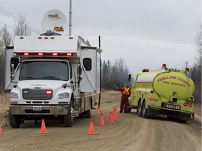 Crews work near Tomahawk Alberta to put out a wildfire on Friday, May 7, 2021 .
