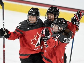 Team Canada's Rebecca Johnston (6), Brianne Jenner (19) and Jocelyne Larocque (3) celebrate an overtime win over the U.S. in this photo from Dec. 3, 2017, at Xcel Energy Center in St Paul, Minn. While Johnston will suit up for Team Scotiabank for the upcoming Secret Dream Gap Tour event, Jenner and Larocque are both on the roster for Team Sonnet.