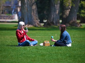 Gillian Meades, left, and Charlotte Van Horne enjoy the day in Riley Park on Monday, May 10, 2021. Calgary Ward 9 Councillor Gian-Carlo Carra is proposing a pilot to allow people to drink alcohol in city parks this summer.