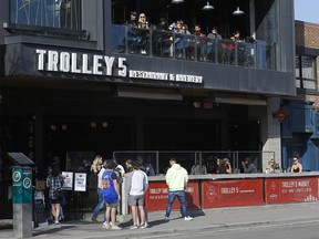 Patrons enjoy the sun on the outdoor patio at Trolley 5 Restaurant and Brewery on 17 Ave. as Premier Jason Kenney announced new measures for Alberta to fight the current surge in COVID cases in Calgary on Tuesday, April 6, 2021.