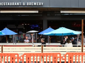People are seen enjoying the patio at Trolley 5 Restaurant & Brewery on 17th Ave. SW. Tuesday, May 4, 2021.
